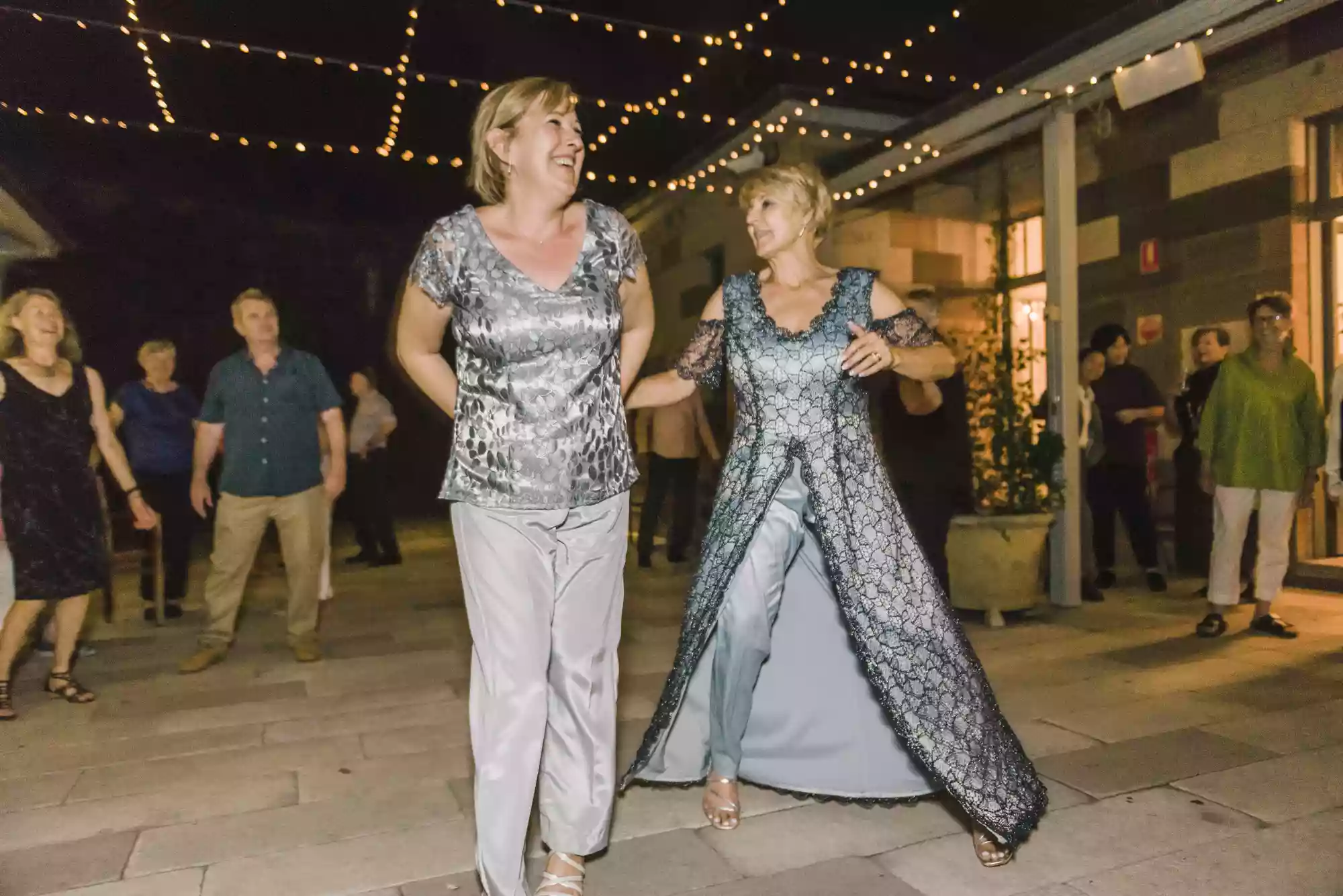 2 womem dancing at a wedding