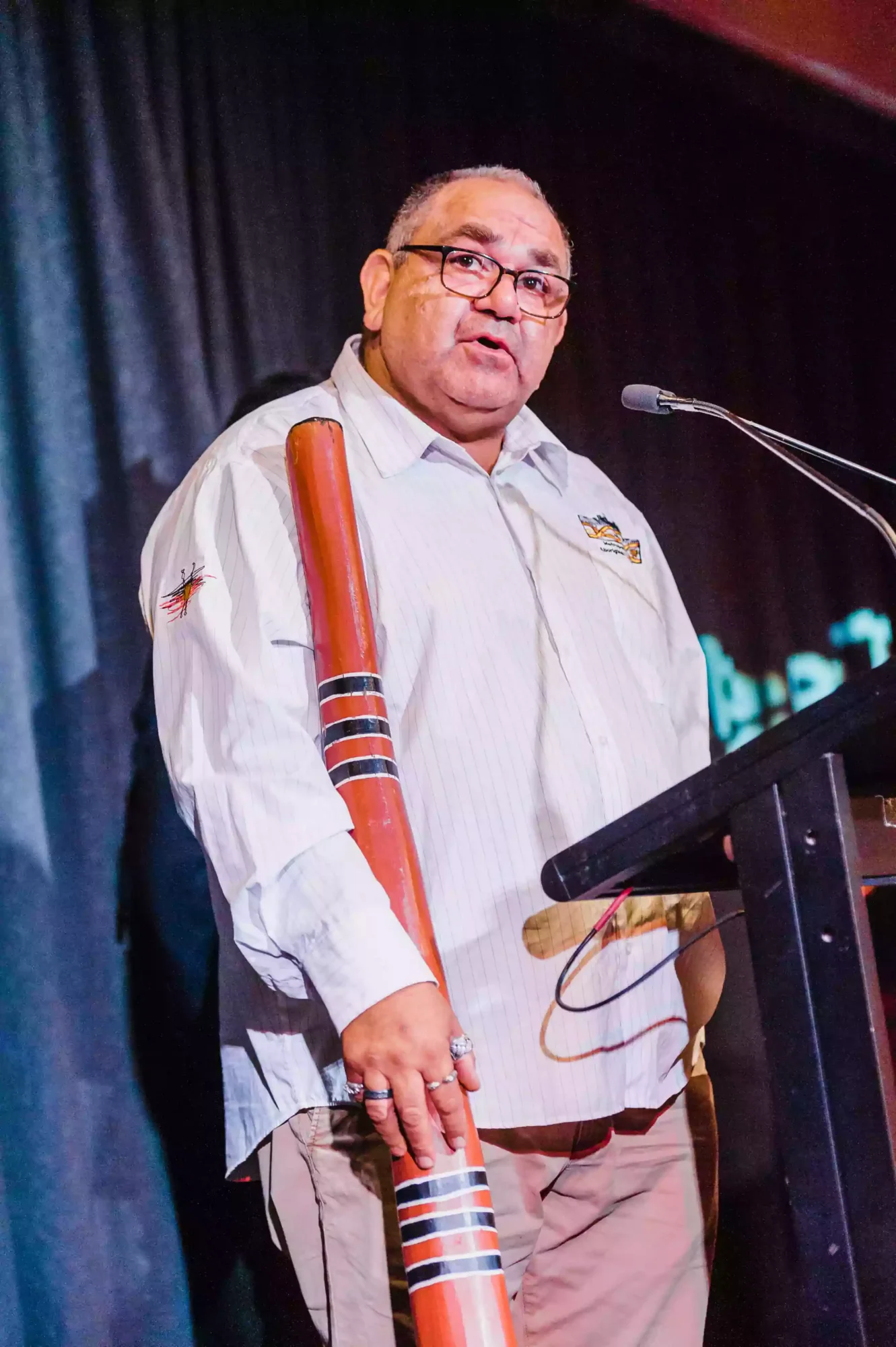 indigenous man holding a didgeridoo