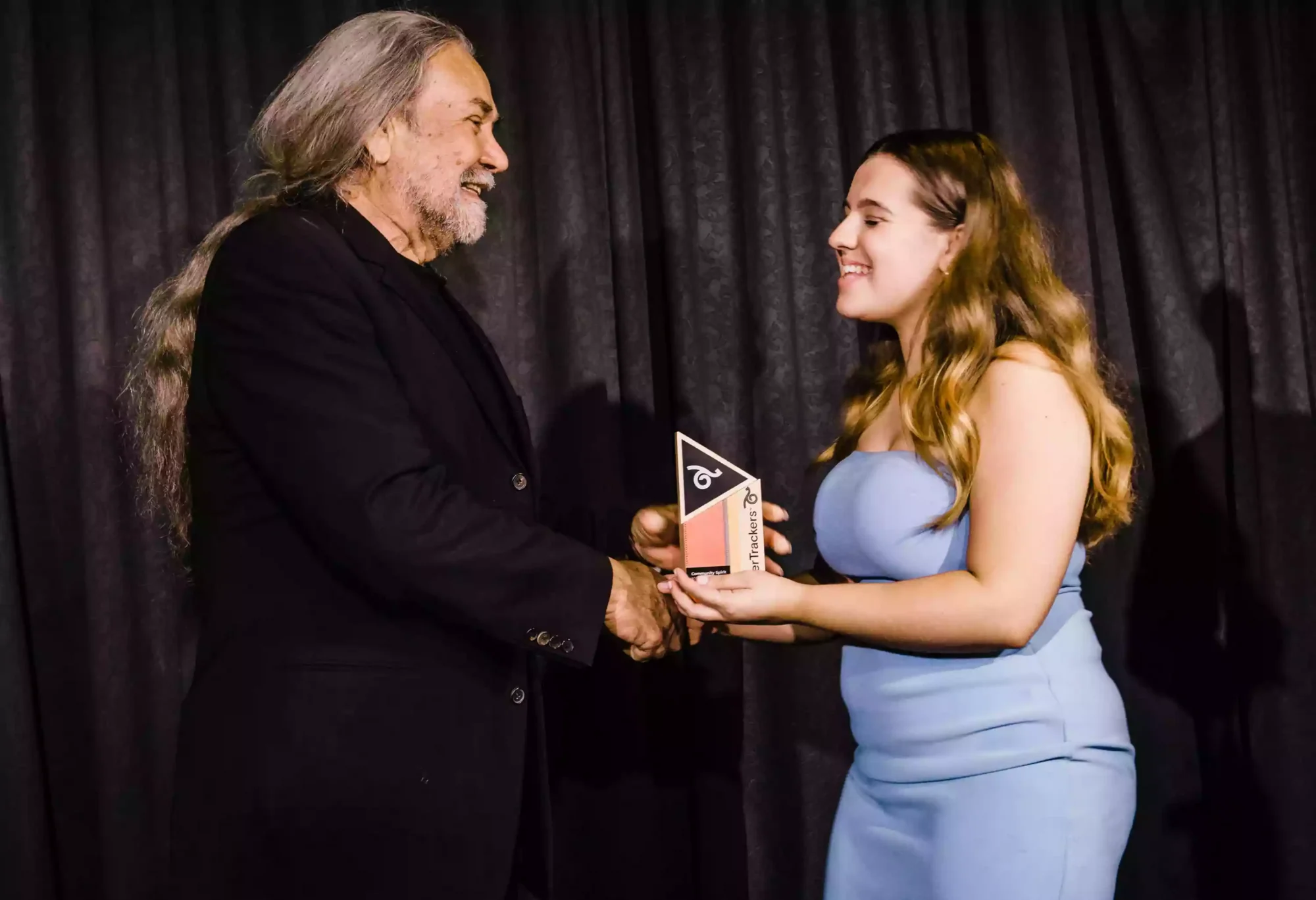 woman receiving an award from an indigenous elder