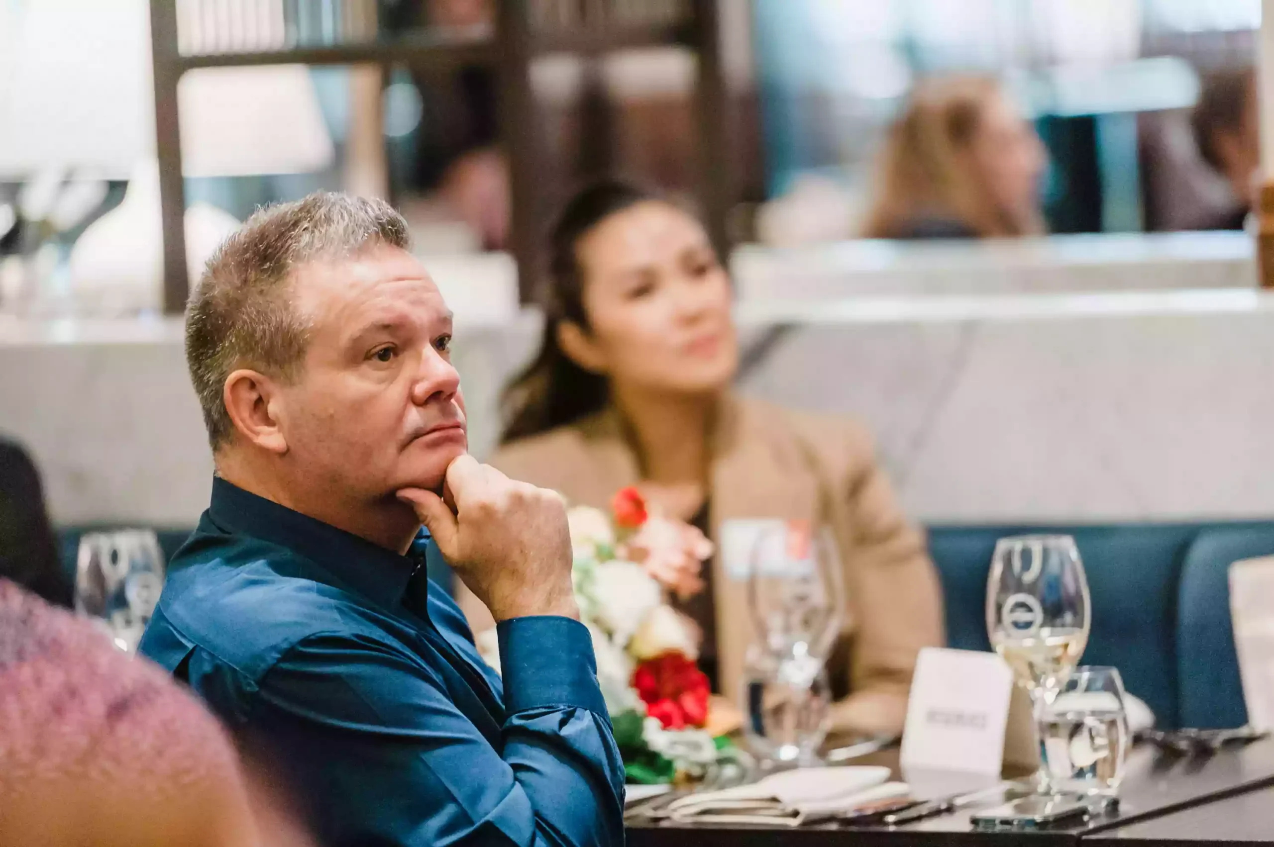 photo of a group of people watching listening to a keynote speaker at a Sydney event as captured by a sydney event and award photographer