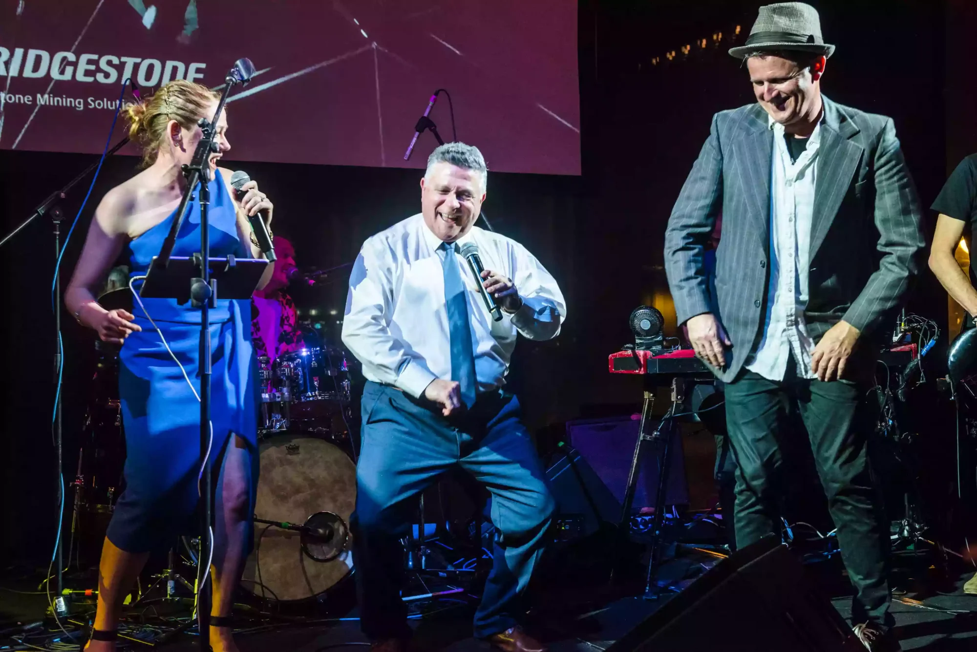 photo of a group of people singing on stage at a Sydney event as captured by a sydney event and award photographer