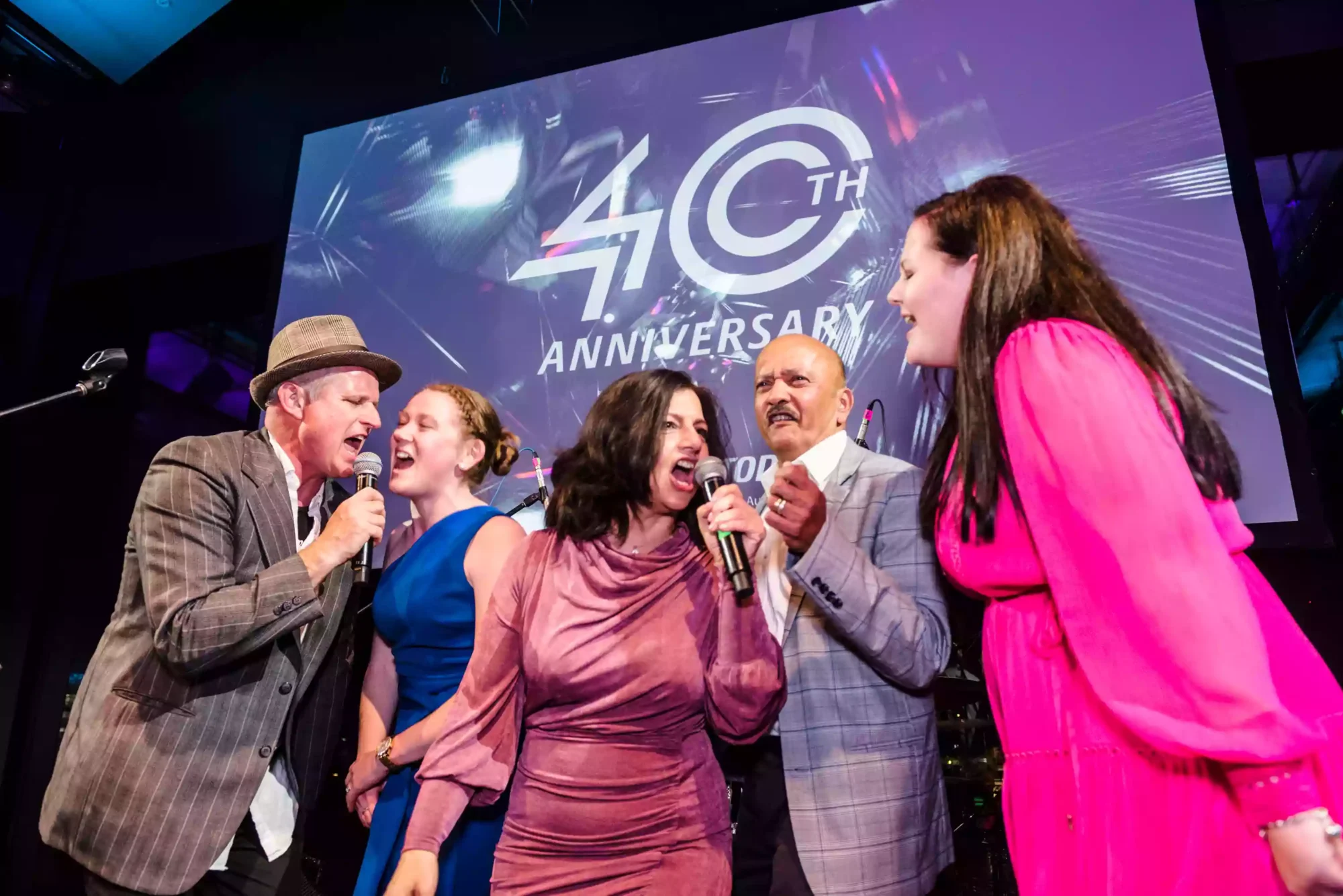 photo of a group of people singing on stage at a Sydney event as captured by a sydney event and award photographer