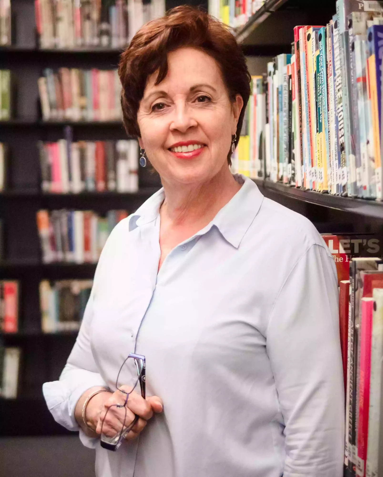Headshot photo of a woman in library as shot by a Sydney professional headshot photographer