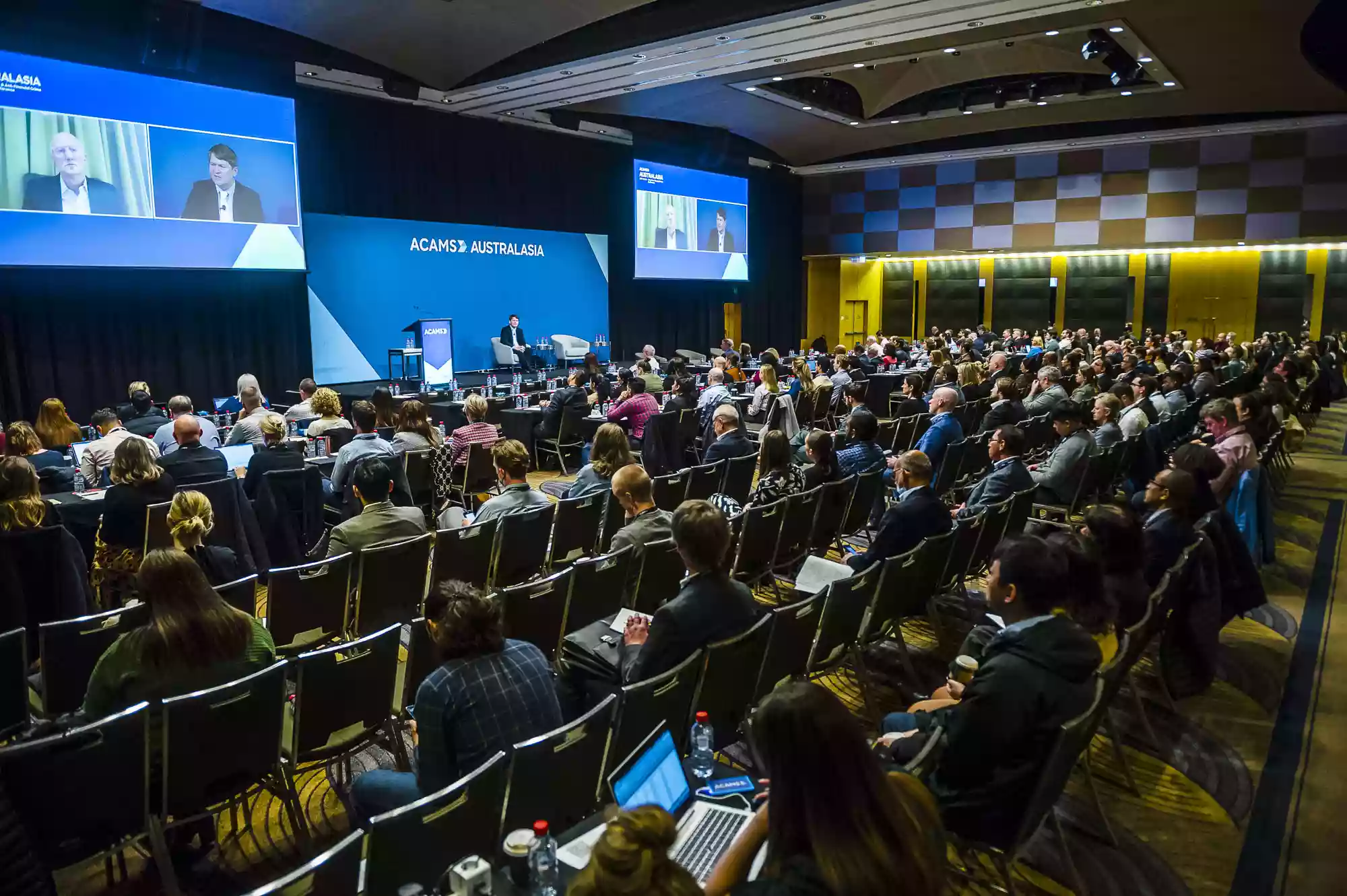full conference room in Sydney watching a keynote speech, photographed by Sydney event and corporate photographer