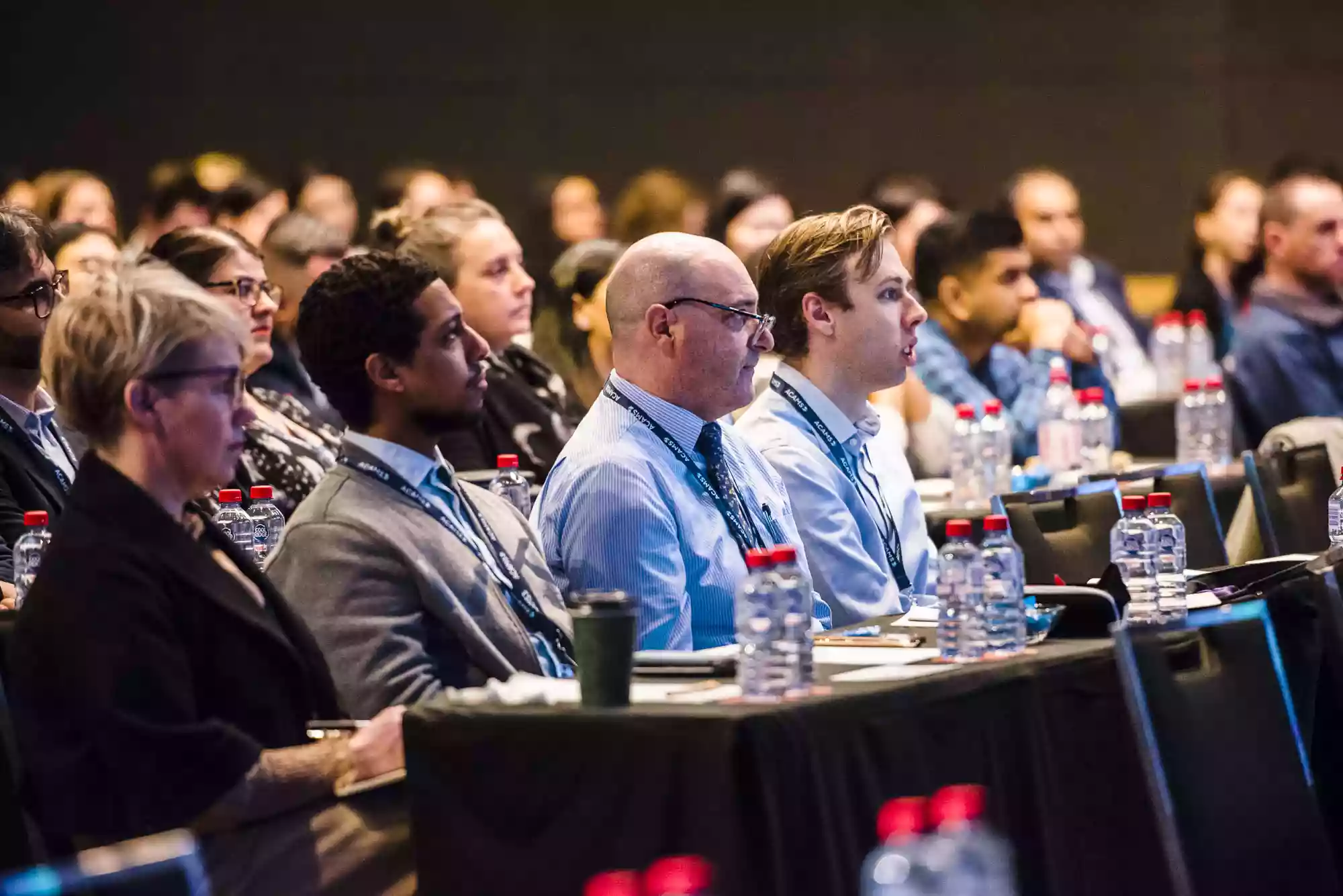 conference attendees in Sydney watching a keynote speech, photographed by Sydney event and corporate photographer